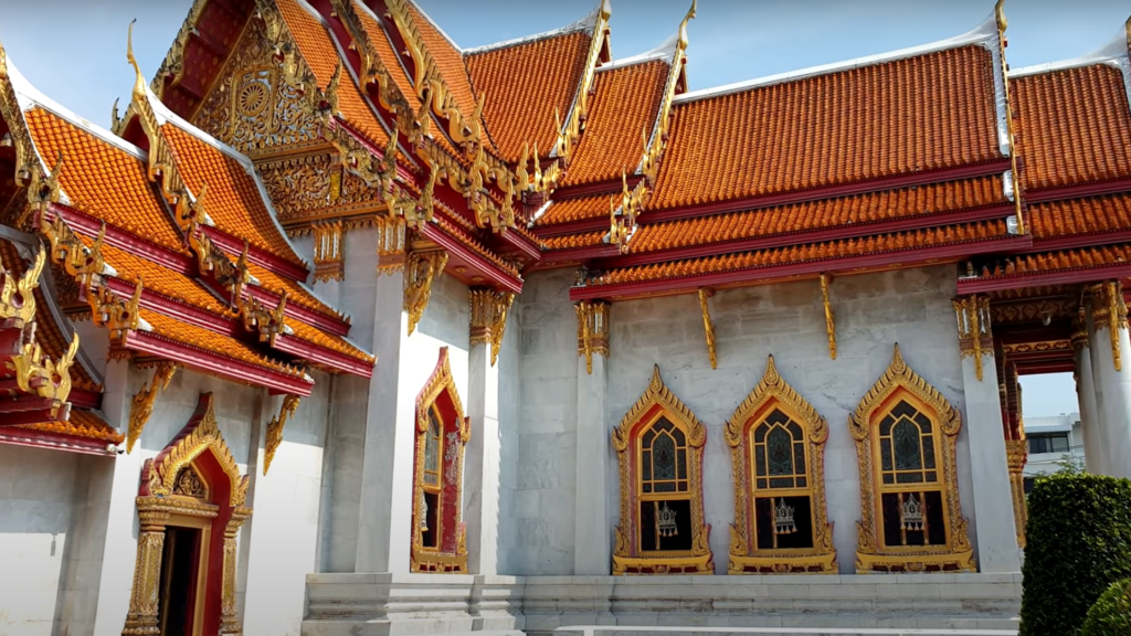 A Buddhist temple with a red and gold tiered roof