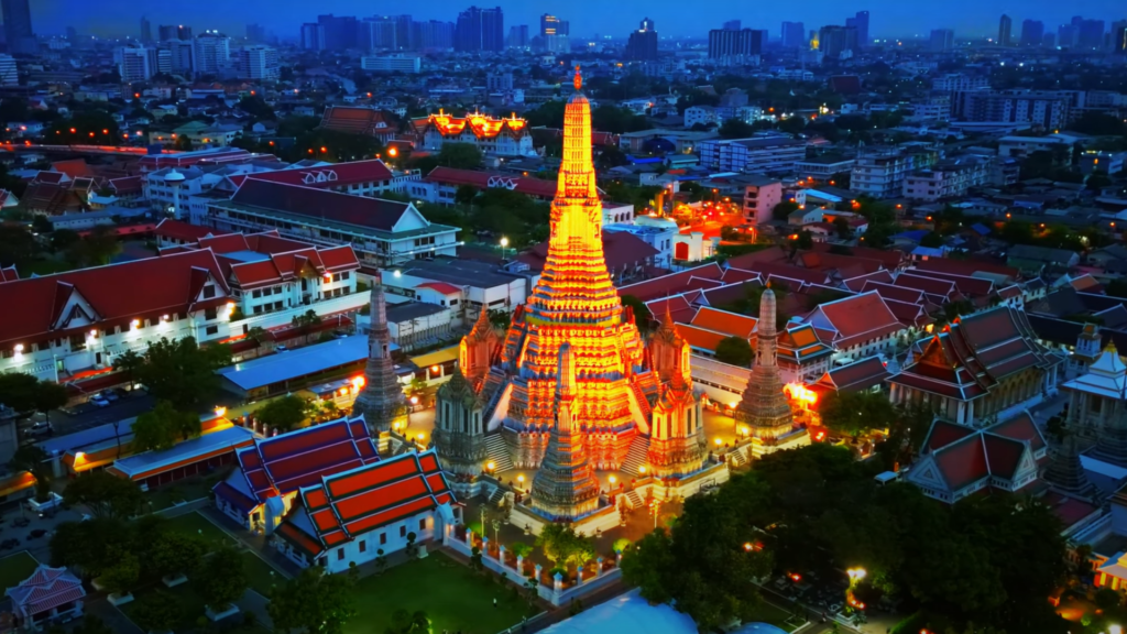 Wat Arun, the Temple of Dawn, illuminated at night along the Chao Phraya River in Bangkok, Thailand.