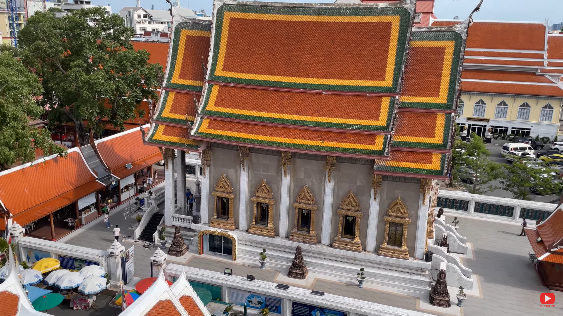 Aerial view of the ornate and colorful roof of Wat Intharawihan temple in Bangkok, Thailand.